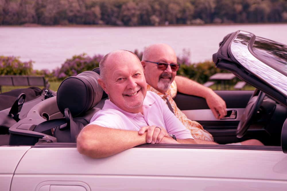 Older-male-LGBT-gay-couple-enjoying-a-sunny-day-and-driving
